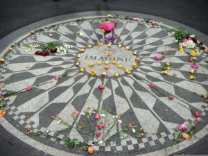 The "Imagine" seal in Strawberry Fields located in Central Park NYC covered in colorful flowers in the shape of a peace symbol.